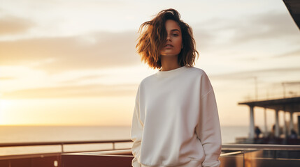 Young Woman in White Sweatshirt on Pier at Sunset