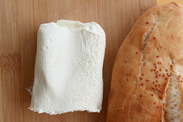 A delectable presentation of creamy goat cheese arranged on a rustic wooden cutting board