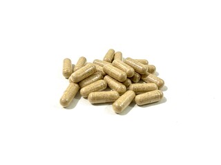 Pile of white turmeric herbal medicine capsules isolated on white background