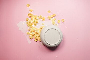 Spilled breakfast cereal on a pink background 