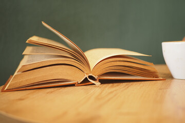 open book and a pencil on wooden table 