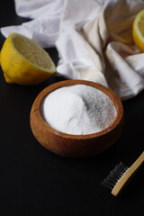 Baking soda and whole lemon on table 
