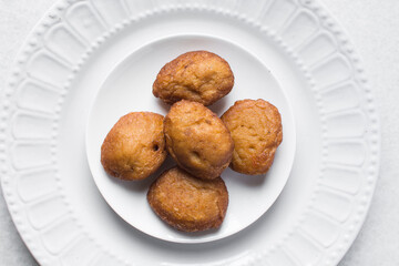 Overhead view of Akara on a white plate, top view of nigerian akara fried beans cake on a plate