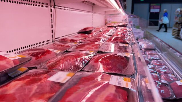 Chilled Meat Display: Supermarket Open Refrigerator with Fresh Pork Fillet, Beef Steaks, Turkey Cuts in Plastic Containers