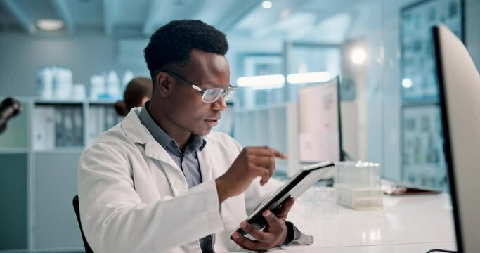 Science, reading and man with tablet in laboratory for medical research, microscope data and analysis. Healthcare, black person at night with digital for biotechnology, check or typing results