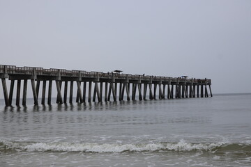 Boardwalk and pier on the beach across the ocean mid-morning. Jacksonville, Florida.