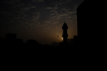 Fototapeta premium Silhouette of mosque minaret in the morning in Makkah city, Saudi Arabia