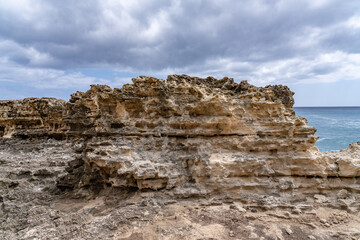 Salt weathering of beachrocks，Beachrock is a friable to well-cemented sedimentary rock. Kaena point / Yokohama bay, Leeward Coast of Oahu, Hawaii.