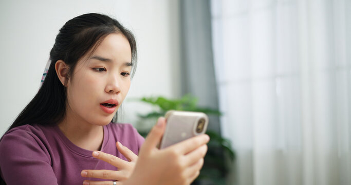 Portrait of Young asian business woman using smartphone for video conference call presenting project plan to colleagues at home office, online meeting for remote work