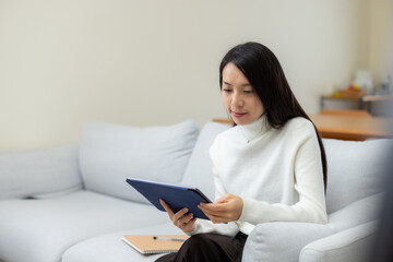 Woman watch on tablet computer at home