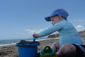 baby on the beach playing