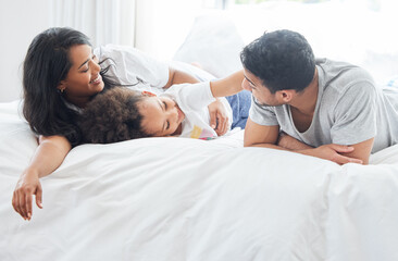 Child, parents and family in bed for morning with love relationship, parent support and bonding...
