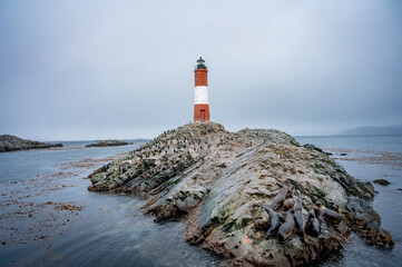 Lighthouse end of world, Canal Beagle, Ushuaia, Argentina with penguins and sea 