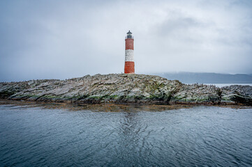 Lighthouse end of world, Canal Beagle, Ushuaia, Argentina with penguins and sea 