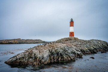 Lighthouse end of world, Canal Beagle, Ushuaia, Argentina with penguins and sea 