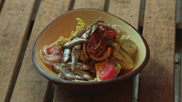 all sliced veg like potato, onion, parwal, tomato, bingal with mourala fish together