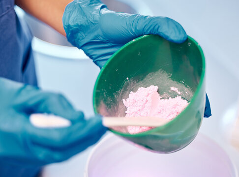 Dentist, hand and powder for dentures impression with dental alginate mould, mixing technique or veneer plaster. Person, orthodontics and silicone material for implant treatment of teeth structure
