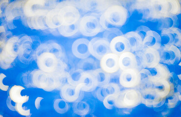 White circle light background pattern with blue backdrop.