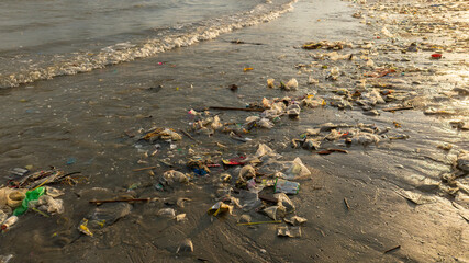 Trash, plastic cups and plastic bags at the beach. environmental problem concept and healing the world	
