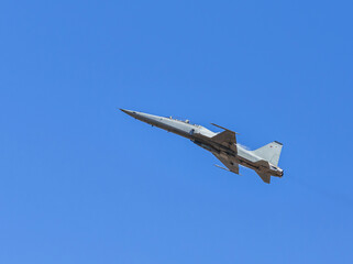 fighter jet military aircraft flying with high speed on blue sky 