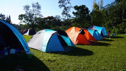 several tents are lined up in a row on the grass