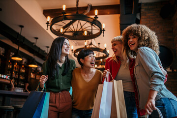 Diverse female friends, smiling and talking, making their way into a restaurant after shopping