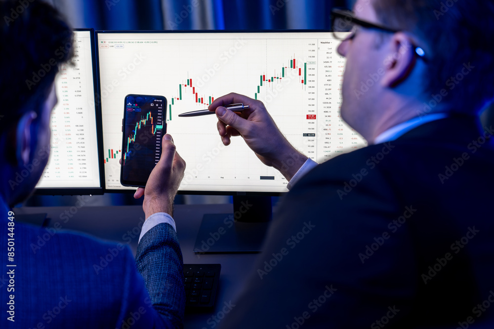 Aufkleber two stock exchange traders researching data on smartphone and laptop screen server of dynamic digita
