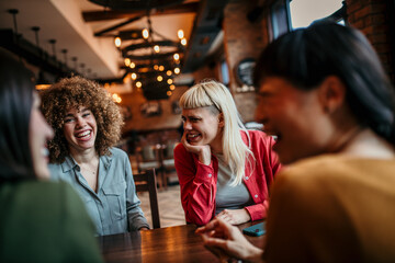 Young people having a great time in cafe, sitting and waiting for a food and drinks