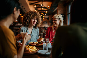 Young happy people having lunch together