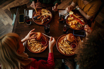 Fast food, lunch or dinner on the table at restaurant, people eating for nutrition and wellness...