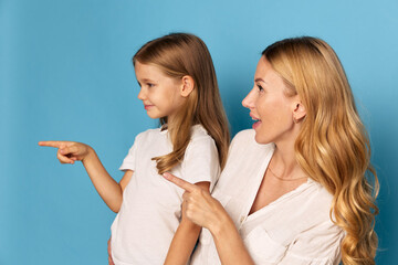 Mother and daughter bonding moment playful interaction and smiles on a vibrant blue background