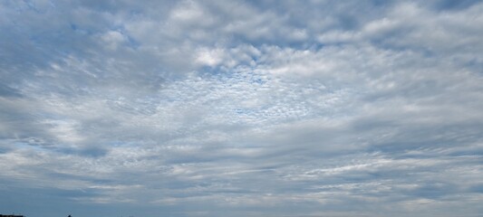 Fluffy white cloudy sky with bright blue sky.