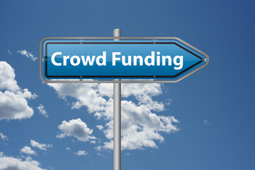 Signpost displaying crowdfunding against sky, symbolizing funding and investment chances