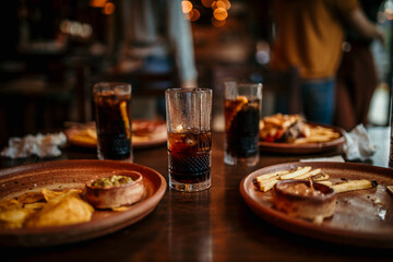 Fototapeta premium Table in the restaurant with a food and drink leftovers after a lunch