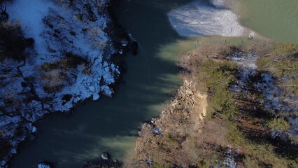 river.with one bank with snow and one without