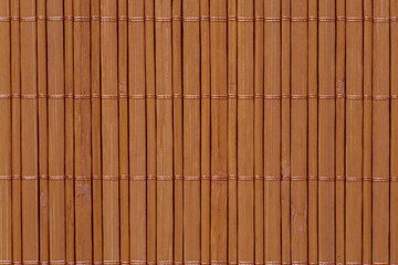 close up of mat made of brown bamboo sticks