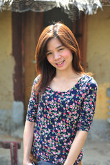 Fototapeta premium Portrait of asian cute woman in colorful flower pattern clothes and rim light on hair smiling with yellow clay background