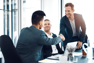 Men, introduction and shaking hands in office at business meeting with smile for welcome, crm and respect. People, handshake and happy with diversity, collaboration and onboarding for job at agency