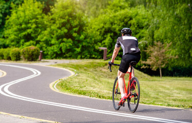 Cyclist ride on the bike path in the city Park
