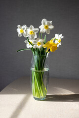 a bouquet of daffodils in a glass vase
