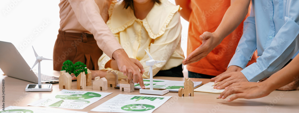 Poster windmill model represented using renewable energy placed during presenting green business on table w