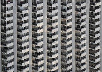background of new high rise apartment building wall with many balcony and a lot windows. facade, exterior backdrop. facade of a multi-storey residential building