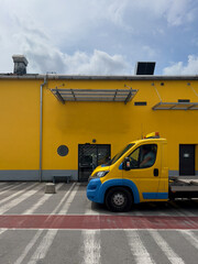 truck with a yellow cab on a yellow wall background, industrial zone