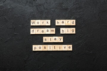 Work hard dream big stay positive word written on wood block. Work hard dream big stay positive text on cement table for your desing, Top view concept © sosiukin