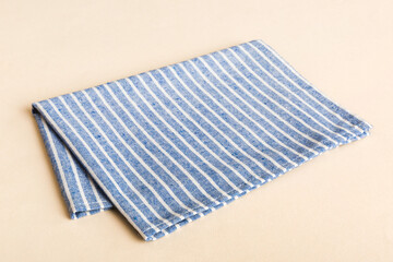 top view with blue kitchen napkin isolated on table background. Folded cloth for mockup with copy...