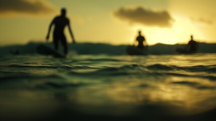 Blurry outlines of surfers paddling out to catch a wave.