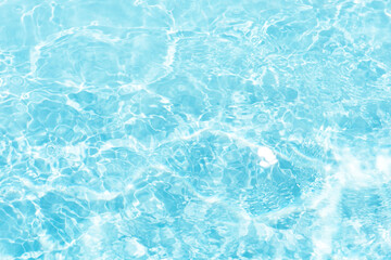 Fototapeta premium Blue water with ripples on the surface. Defocus blurred transparent blue colored clear calm water surface texture with splashes and bubbles. Water waves with shining pattern texture background.
