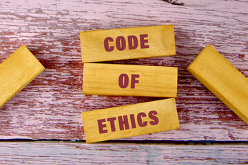 Code of ethics text on table, concept. code of ethics word written a conceptual phrase on wooden...