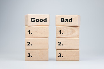 Good versus Bad, comparison lists concept by stacks of the wooden blocks, to make a dicision