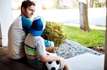 Love, bonding and father and son relax on porch with soccer ball for learning, teaching and game...